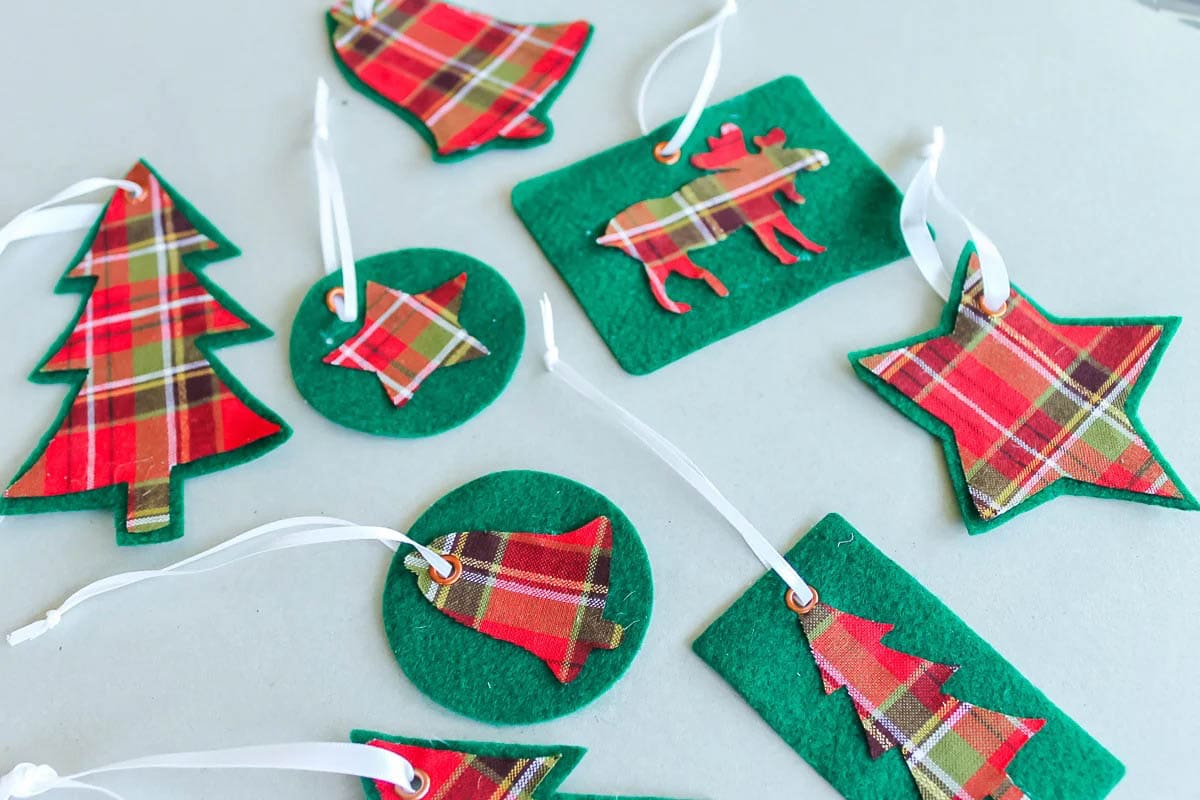 Assortment of plaid Cricut Christmas ornaments.