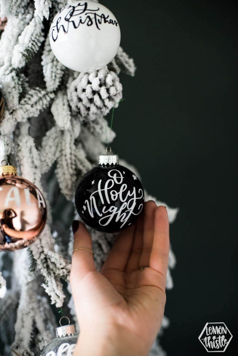 Black round ornament with white vinyl letting