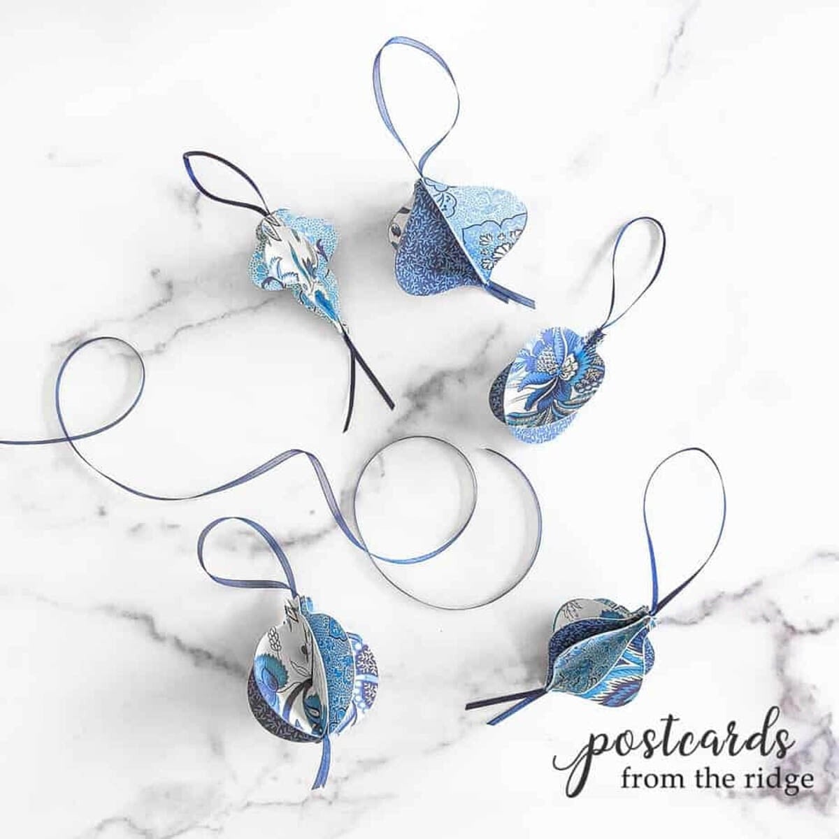 3D paper ornaments in blue and white made with a Cricut machine
