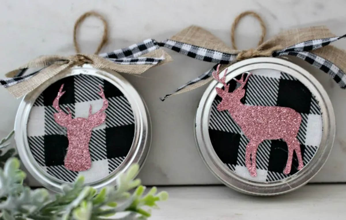Glitter vinyl reindeer on buffalo check fabric in a mason jar lid