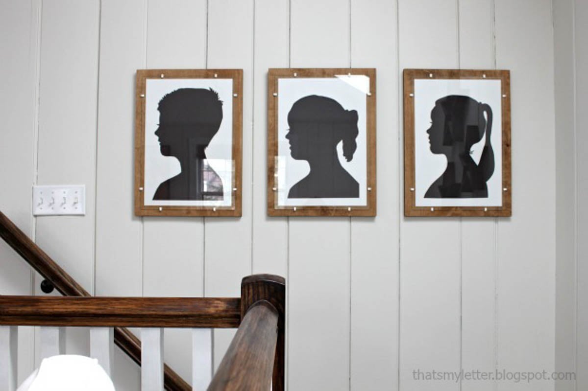 Silhouettes framed on plywood with glass