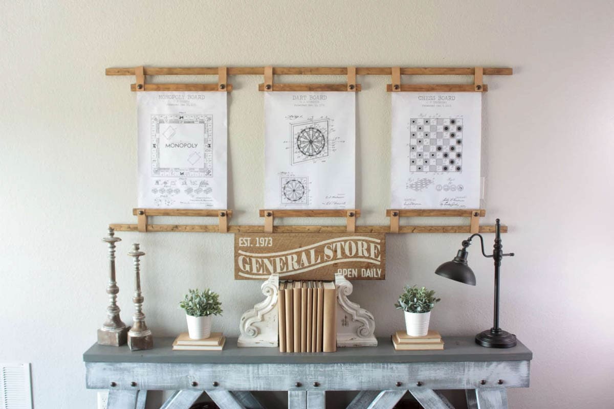 Three wood and leather picture frames hung with dowels