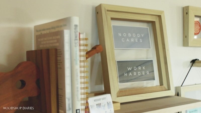 DIY floating picture frame sitting on shelf