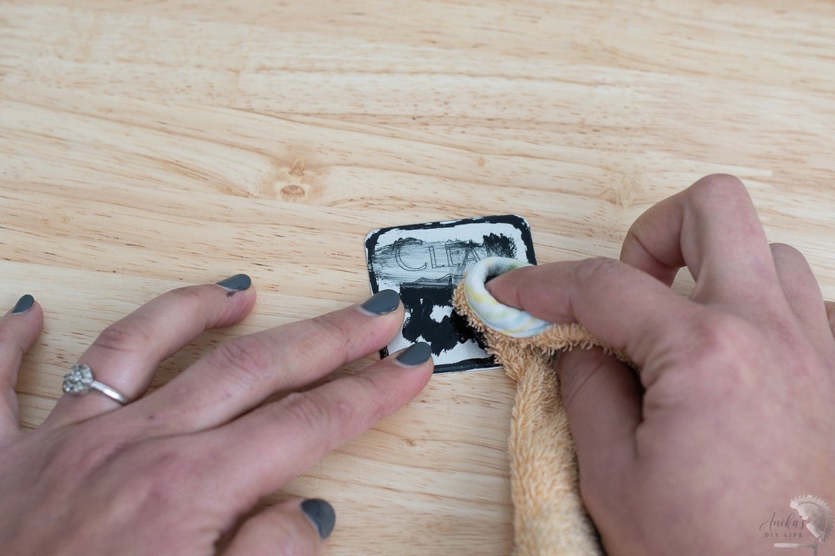 rubbing off the enamel paint from the engraving