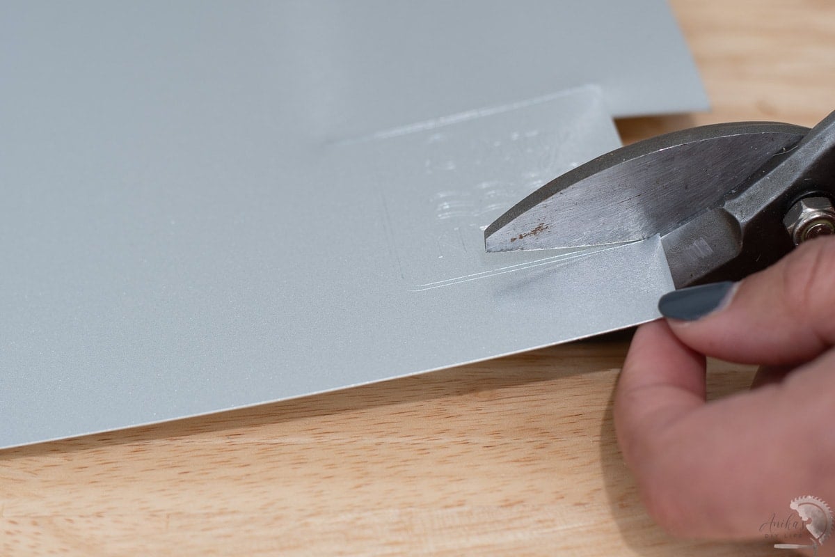 cutting out the engraved sheet for the metal dishwasher magnet