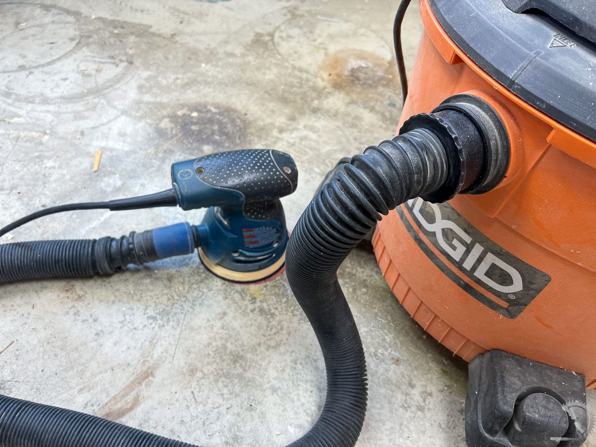 random orbital sander hooked up to the shop vac with special hose adapter