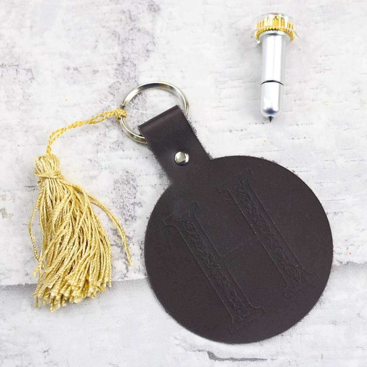 Black leather engraved keychain with gold tassel