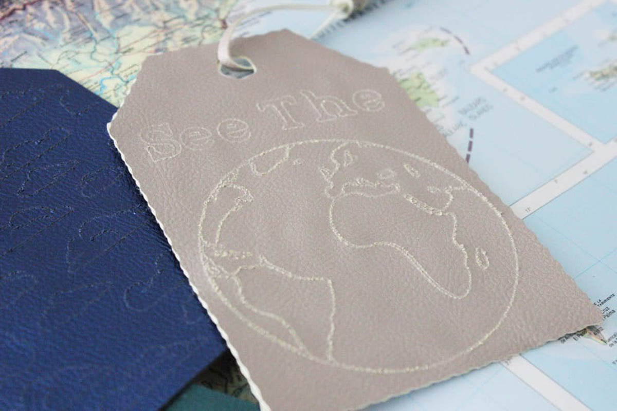 Blue and gray leather luggage tags engraved with Cricut engraving tip
