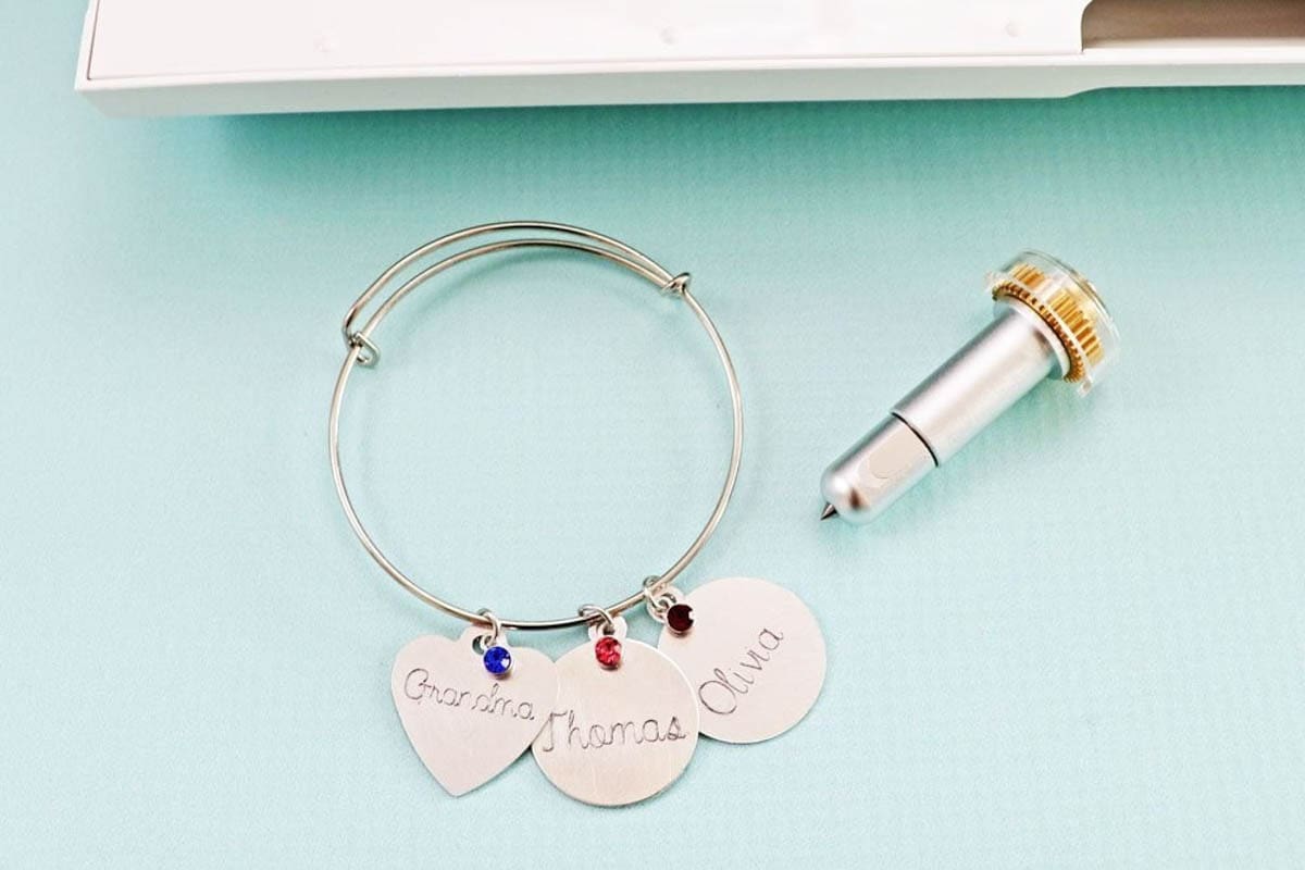 Metal charms for bracelet or necklace engraved using the Cricut engraving tip
