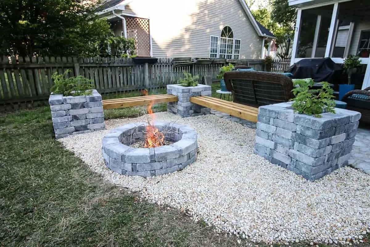 modern DIY fire pit idea with stone planter benches