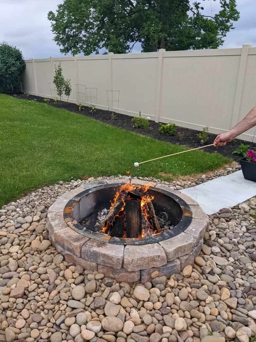 in-ground fire pit with rock surround