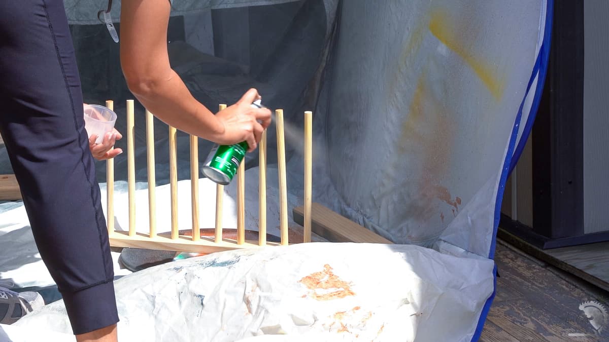 Woman sealing dowels using spray finish