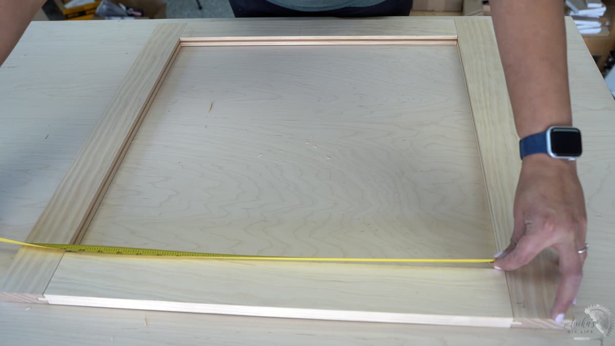 measuring the door opening to check the size for the center panel