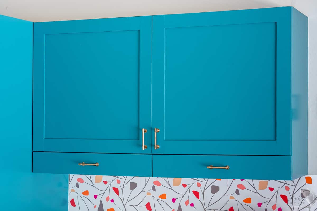 Turquoise Shaker style doors in laundry room