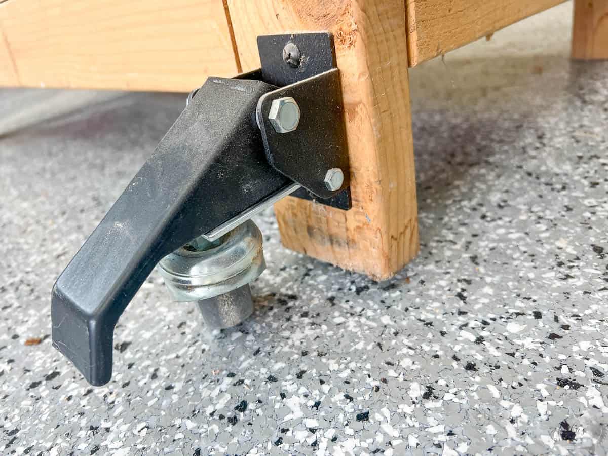close up of the drop down casters on a workbench