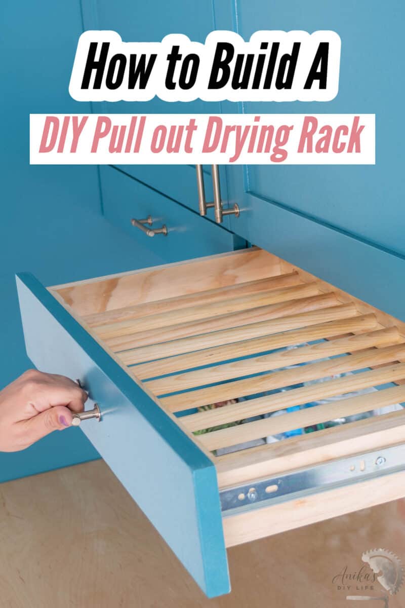 wooden pullout drying rack in a blue laundry room