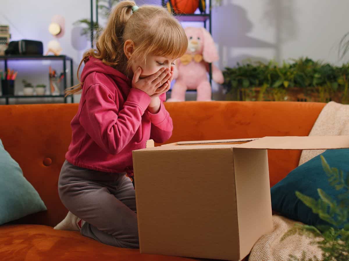 little girl opening a subscription box