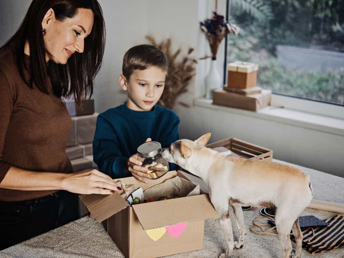mom and son with dog opening subscription pet box