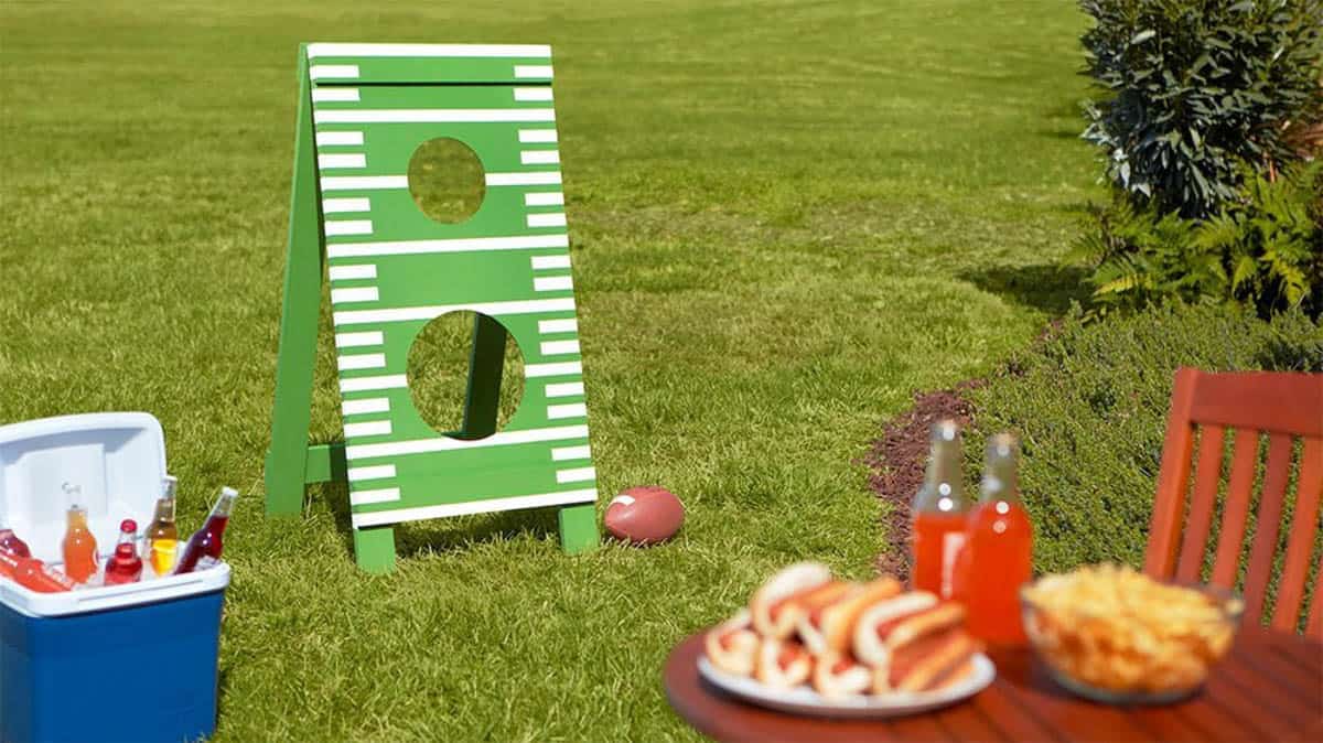 Football toss game with green painted board
