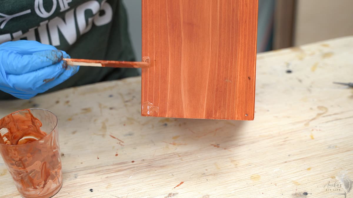 Applying a stainable wood filled to the planter
