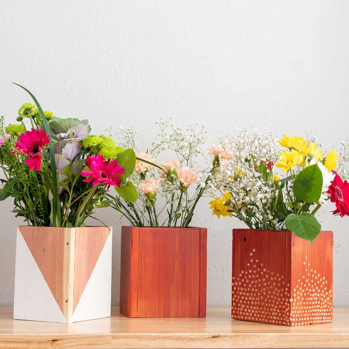 Learn how to make easy wood vases or planters using inexpensive fence pickets to add to your home, give as a gift or wedding or baby shower centerpiece.
