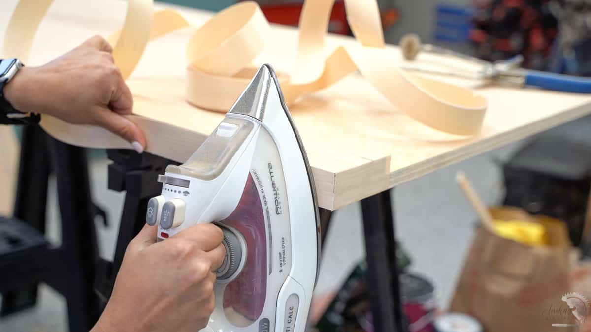 applying edgebanding using an iron to the thick plywood countertop