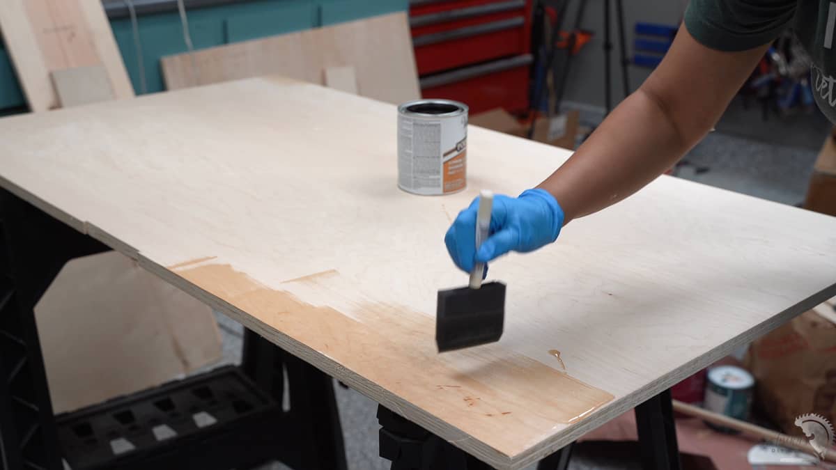 applying finish to the wooden countertop