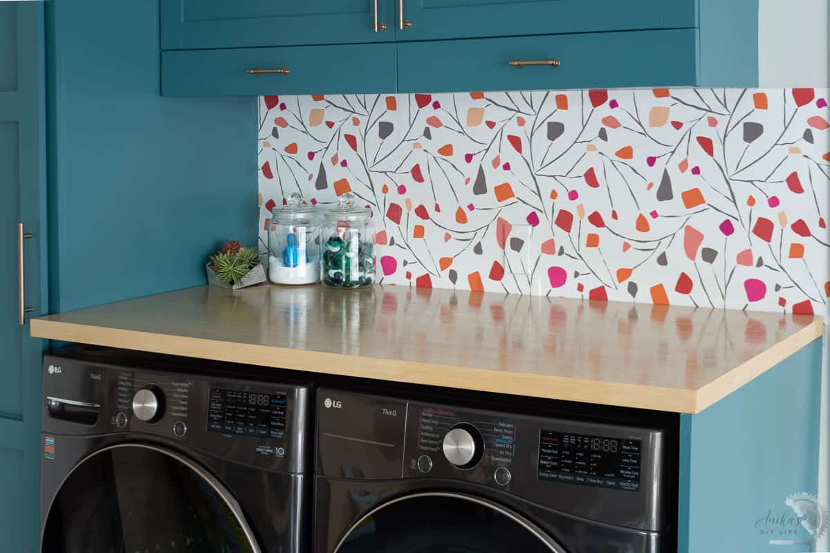 close up of plywood countertop in laundry room with blue cabinets