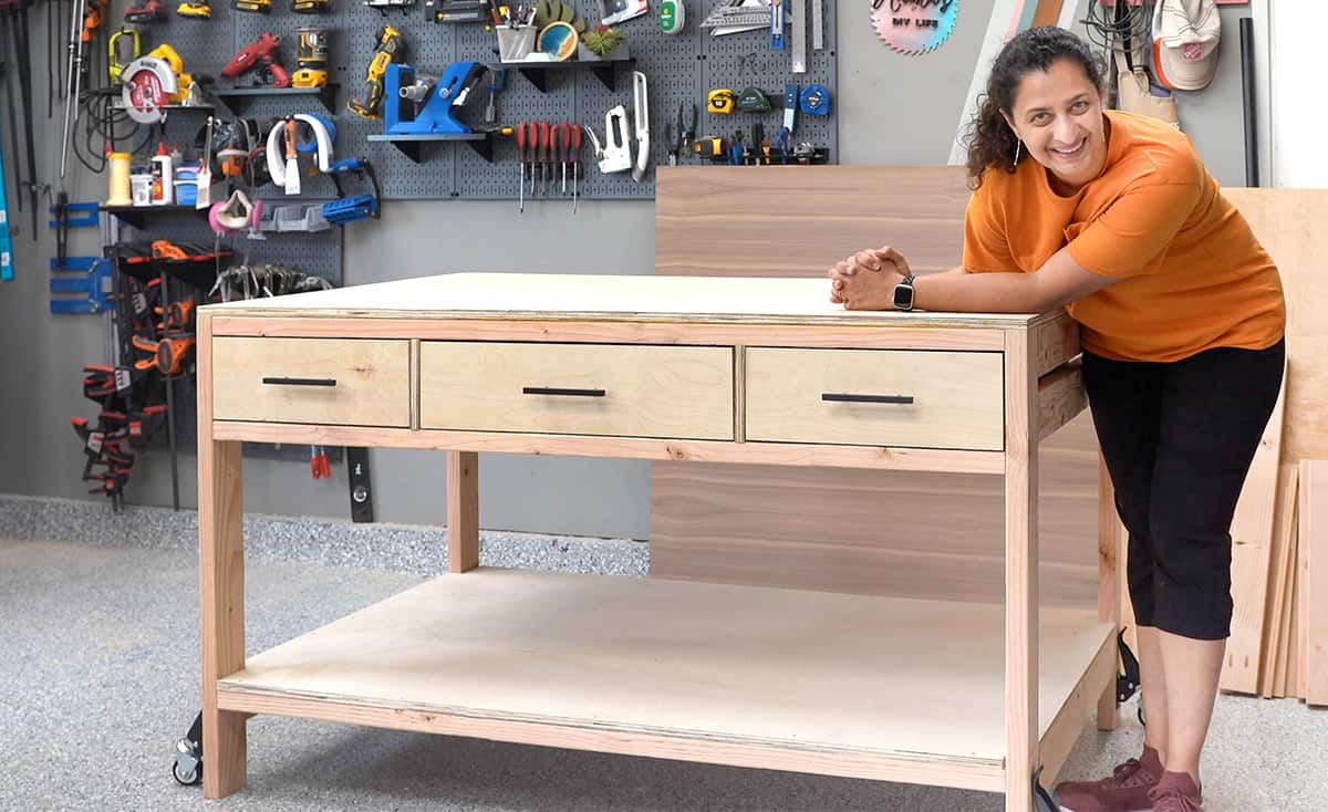 Woman with workbench with drawers and storage in workshop