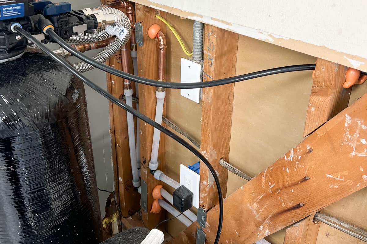 Open wall with plumbing inside for a garage laundry area
