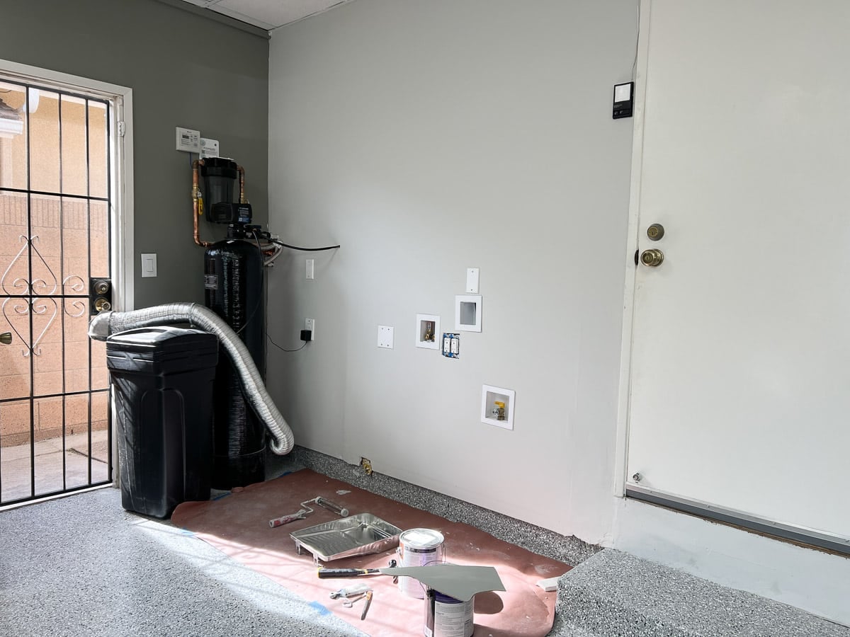 Laundry area in garage with wall fixed up.