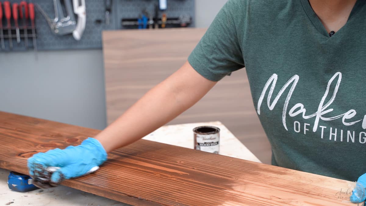 woman wiping off stain on board