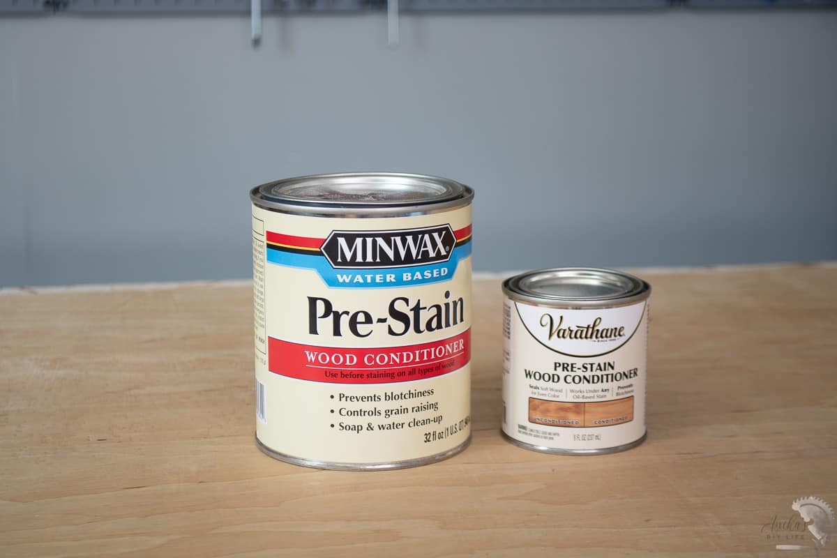 Oil based and water based pre stain conditioner on workbench in workshop