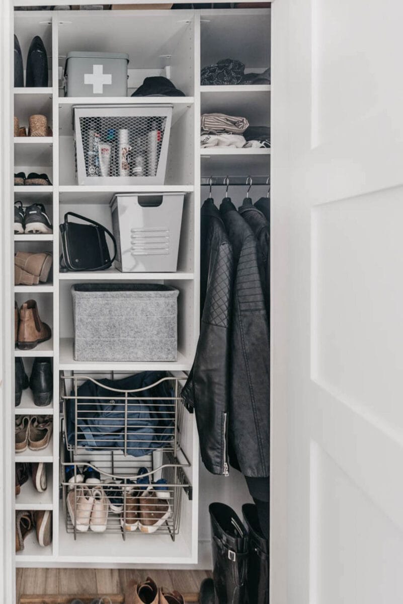 organized entryway closet with shelves and hanging rod