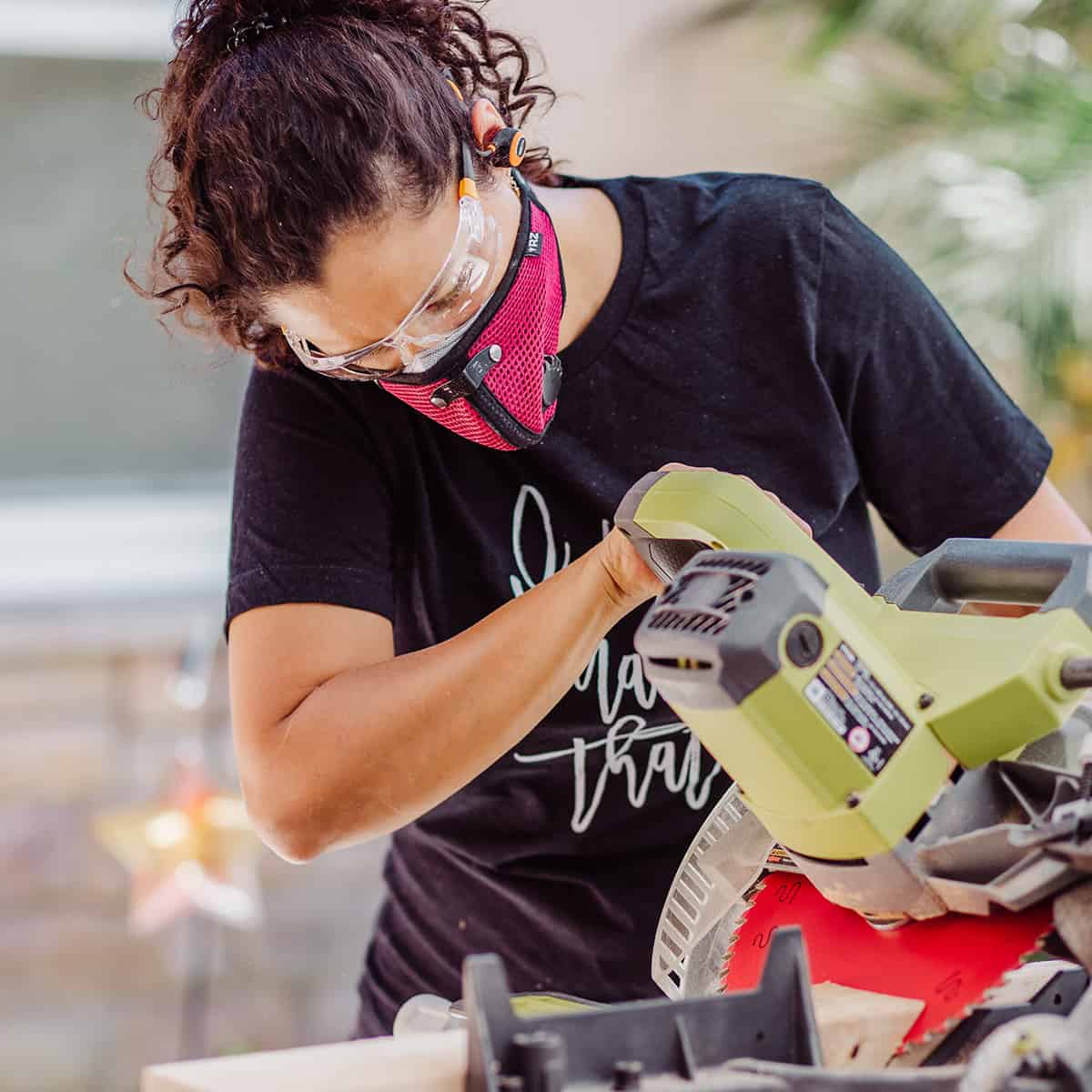 Anika using a miter saw