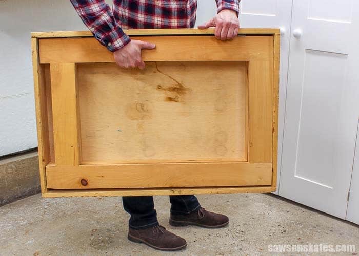 Man carrying a folding workbench