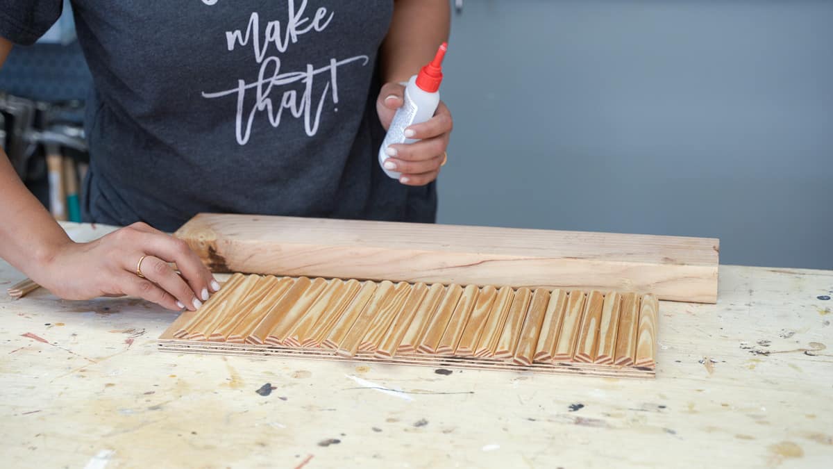 woman attaching molding to the drawer front to make a fluted front
