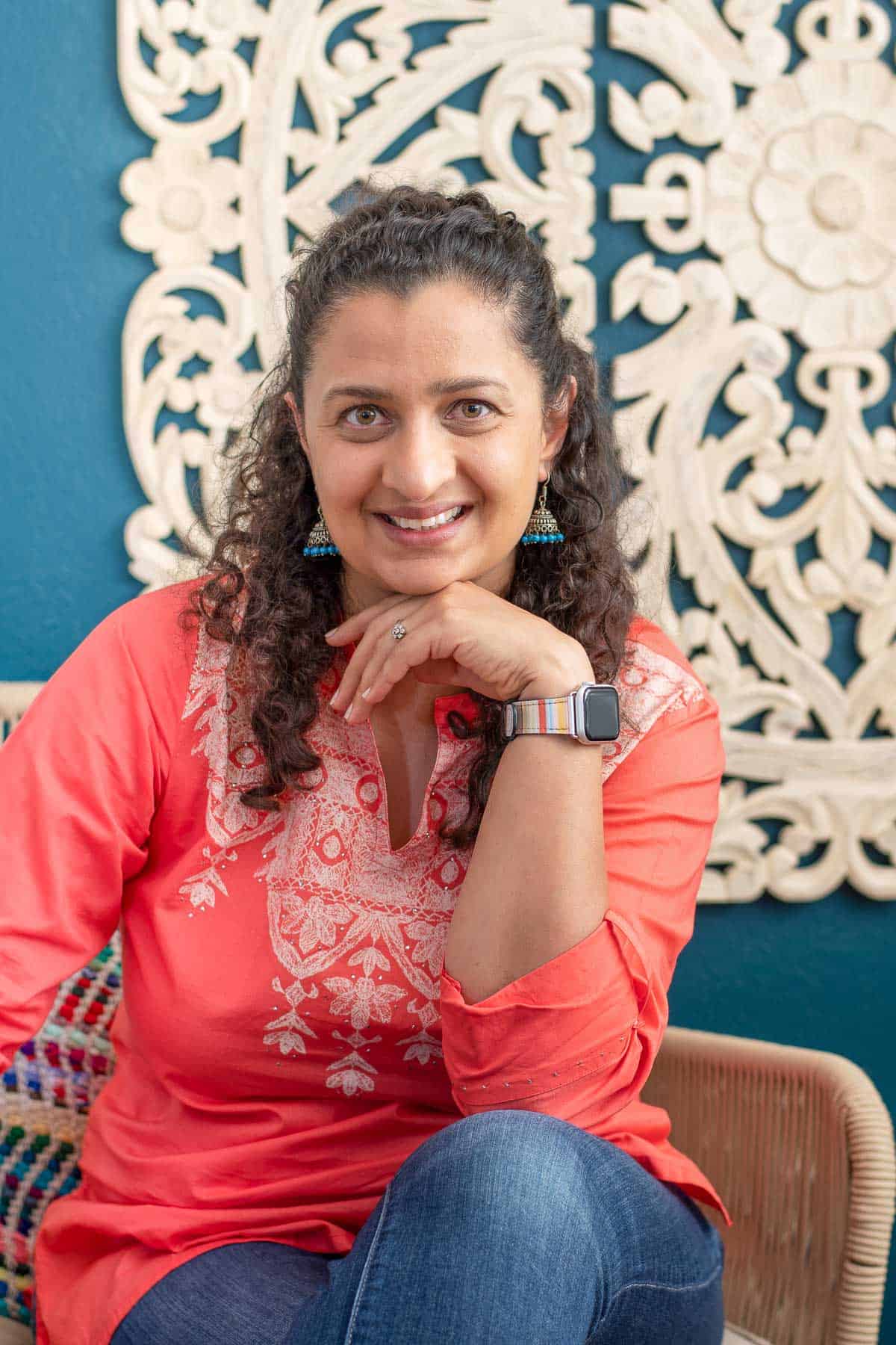 anika gandhi in front of blue wall