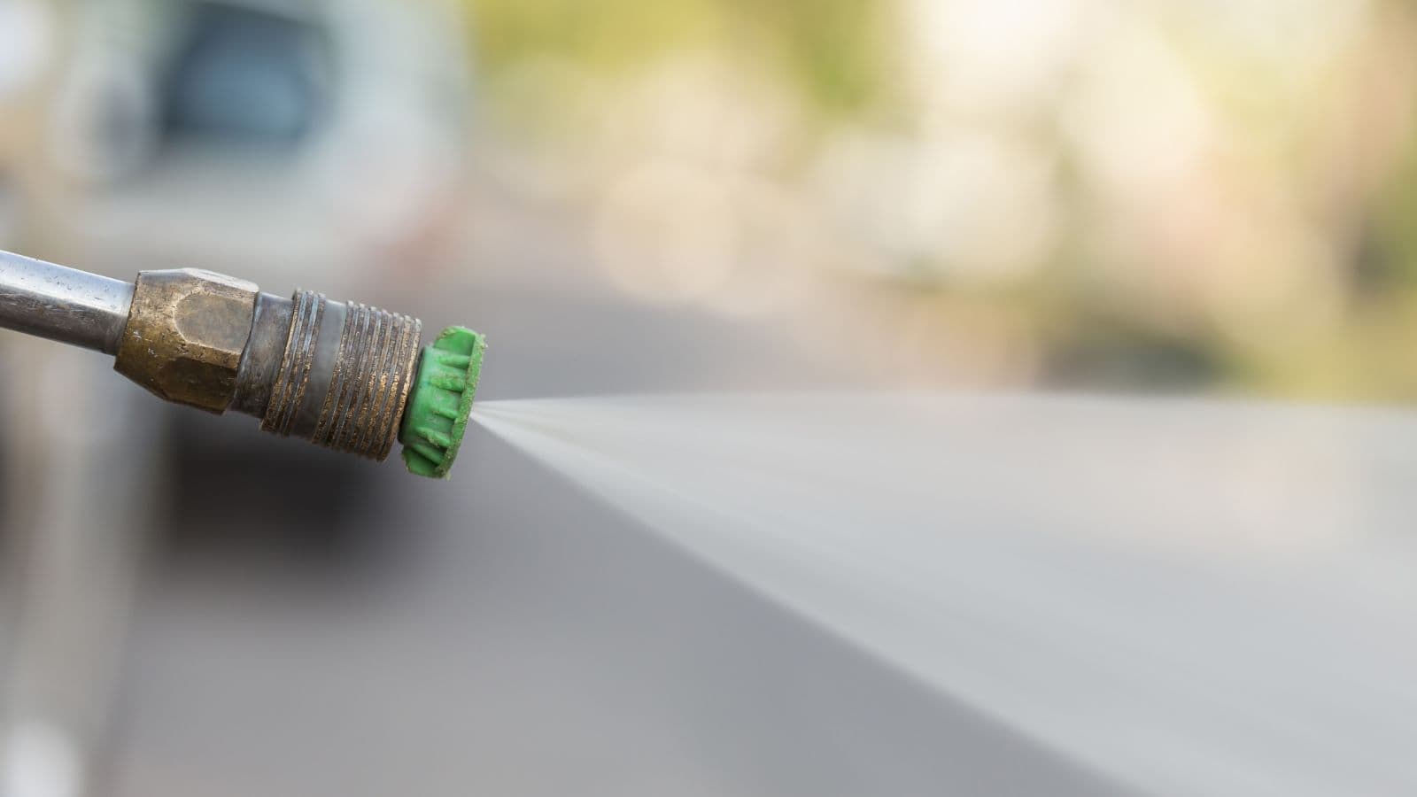 close up of power washer nozzle spraying water