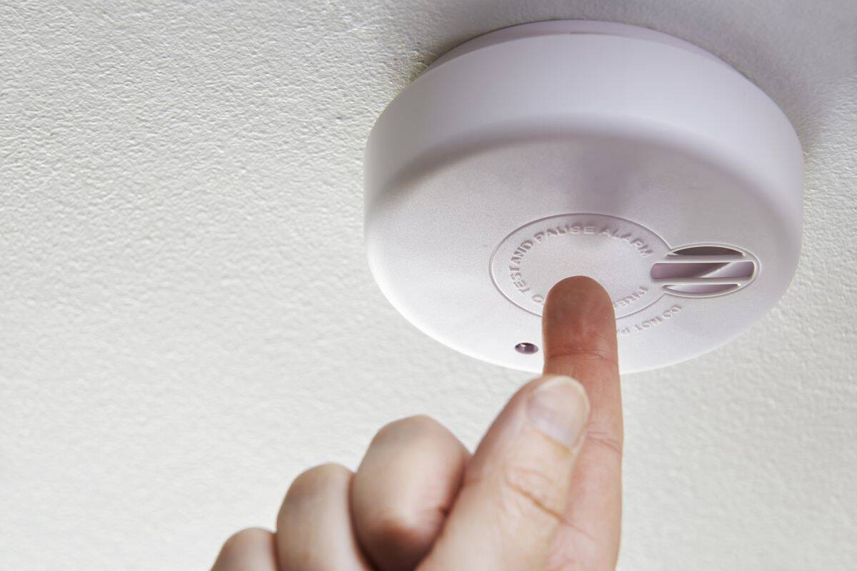 checking the battery on a smoke detector