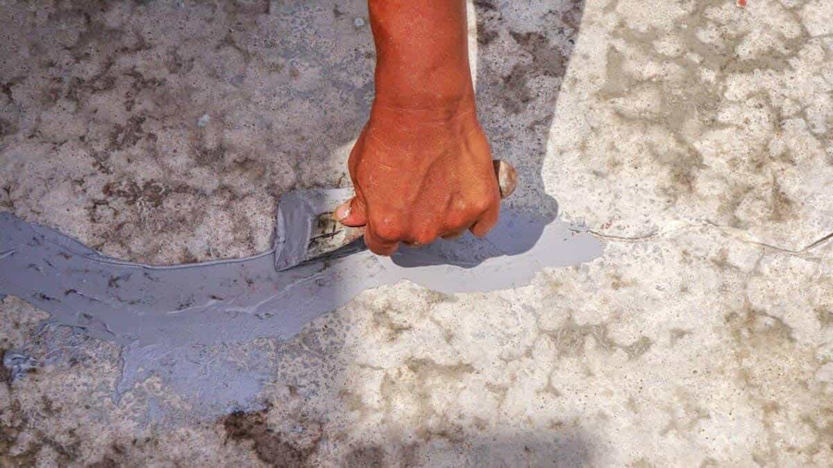 smoothing out cement patch in a driveway