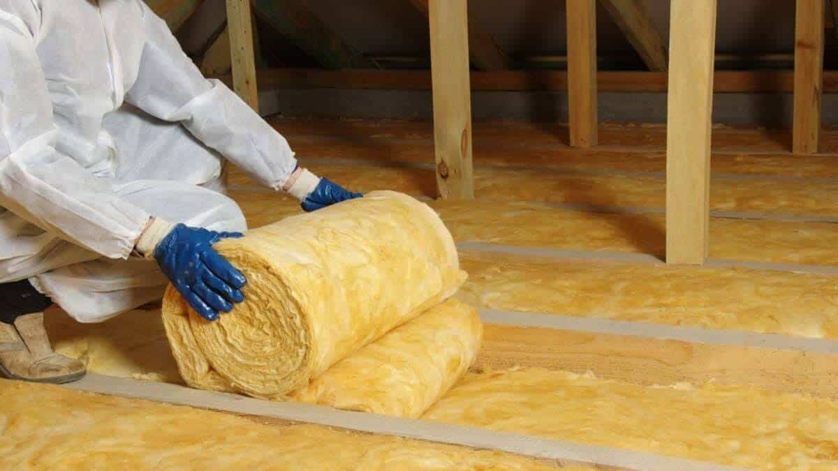 rolling out insulation in an attic