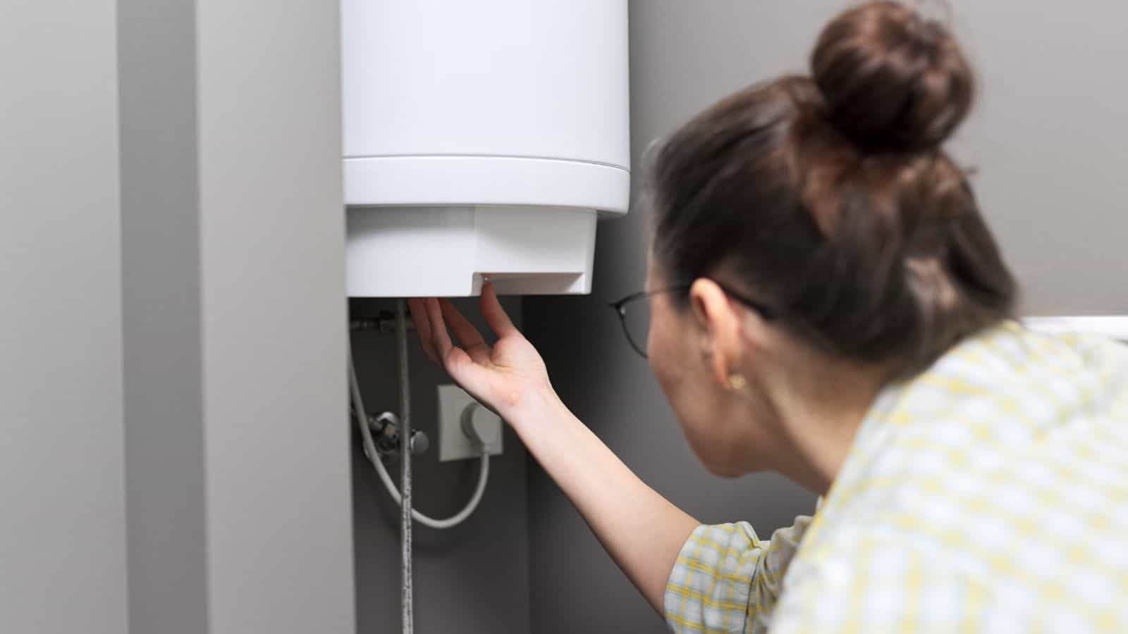 woman checking water heater