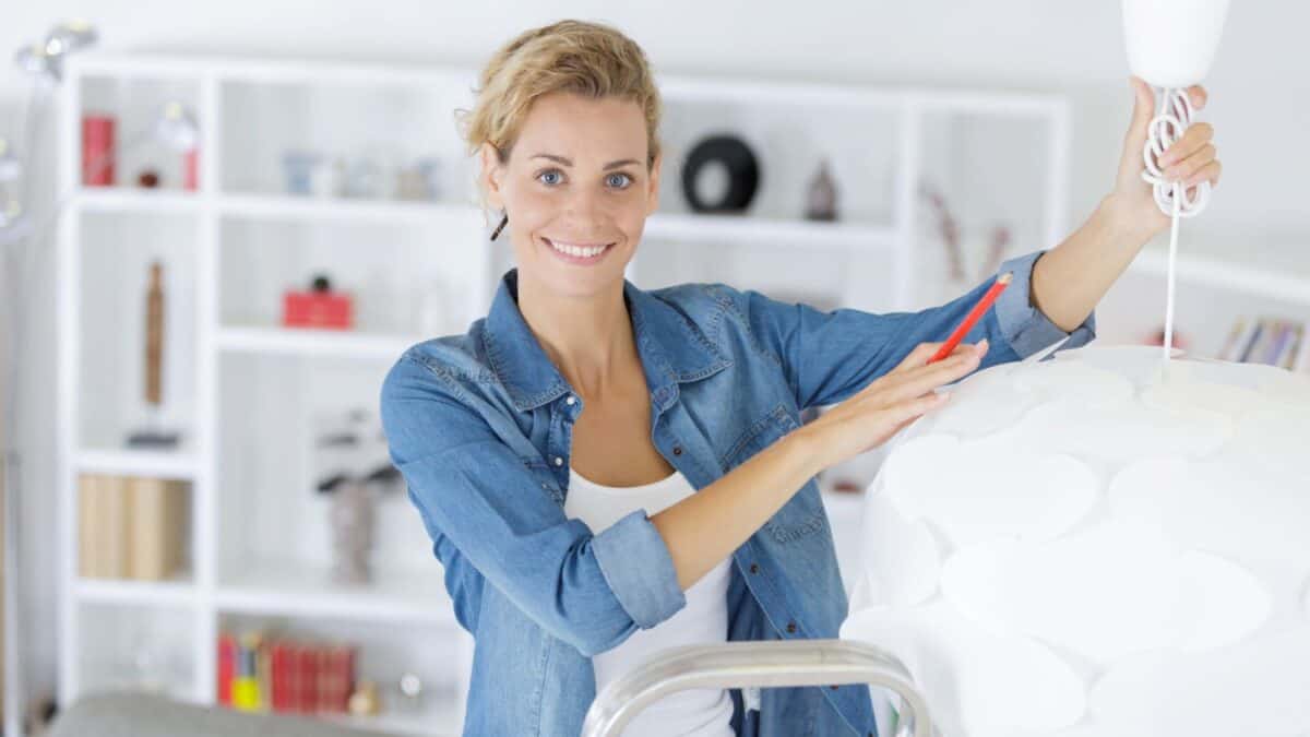 woman holding light fixture