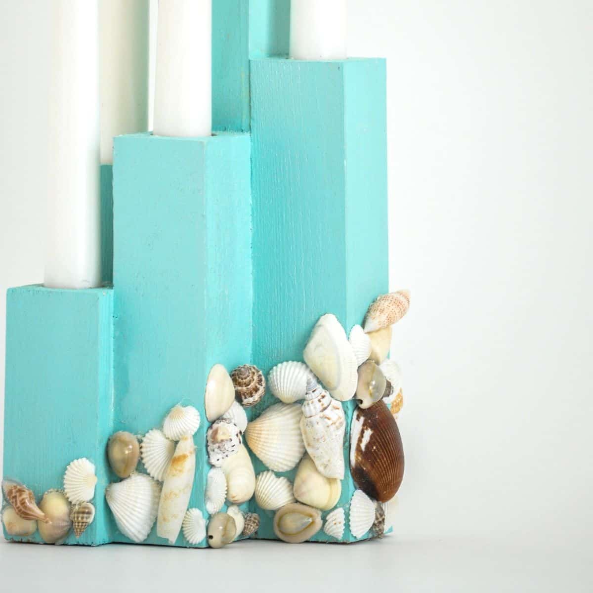 candle holder made with 2X2s and decorated with seashells