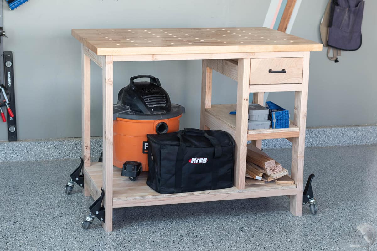 small DIY workbench in woodworking workshop with tools stored