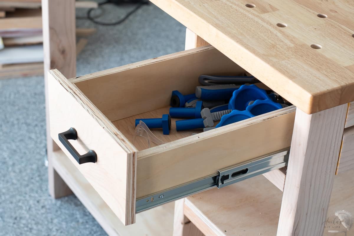 Inside the drawer of the workbench with the Kreg bench dog accessories.