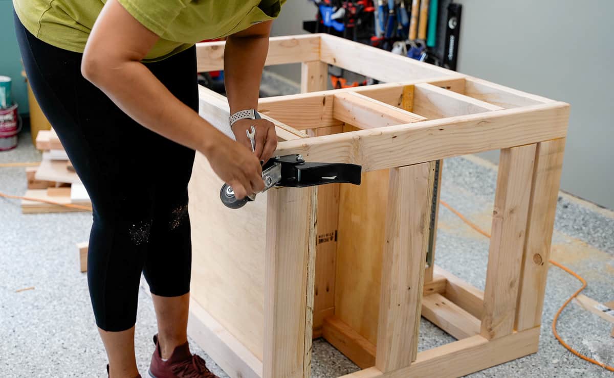 Woman attaching casters to the workbench