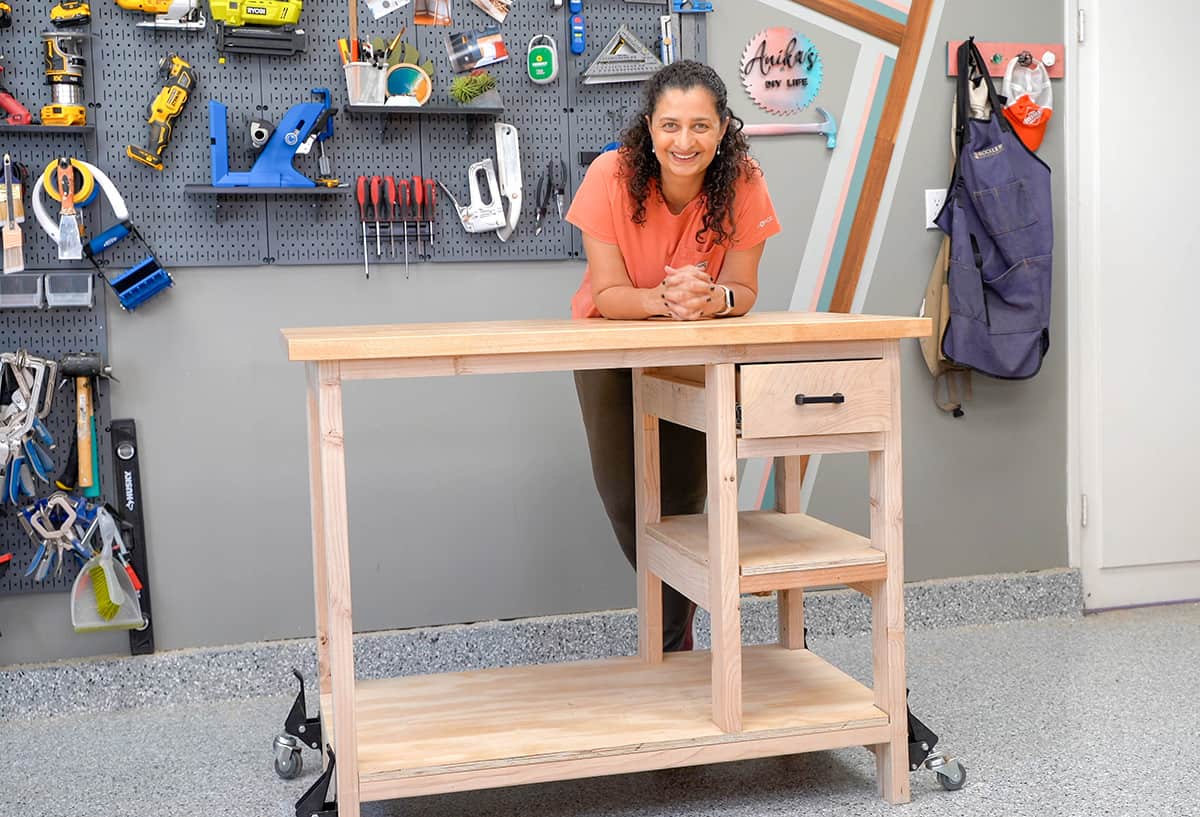 Anika with new DIY workbench with storage  in workshop