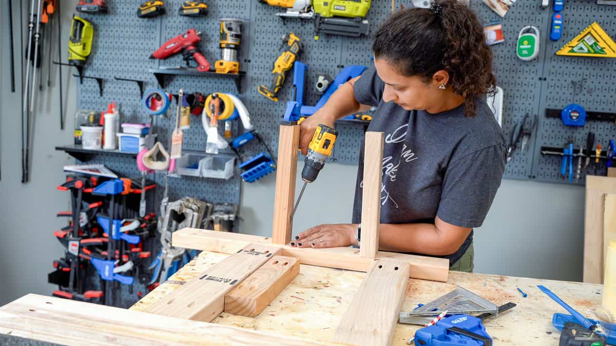 Woman attaching 2x4 boards using pocket hole screws